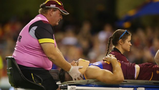 Stefan Martin of the Lions is stretchered from the field.