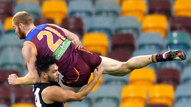 Hard man: Lions veteran defender Daniel Merrett crashes into Port youngster Jarman Impey.