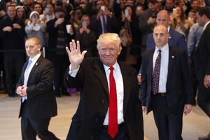 President-elect Donald Trump waves to the crowd as he leaves the New York Times building following a meeting, Tuesday, Nov. 22, 2016, in New York.