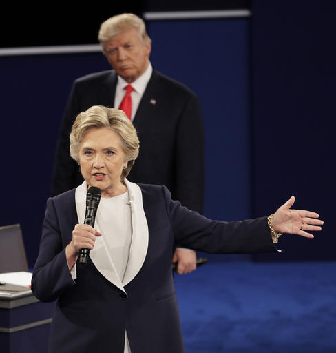 Republican presidential nominee Donald Trump listens to Democratic presidential nominee Hillary Clinton during the second presidential debate at Washington University in St. Louis, Sunday, Oct. 9, 2016. (AP Photo/John Locher)