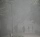 People walk in a park amid heavy dust and smog on November 7.