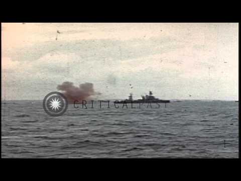 USS Texas bombards the beach of Normandy, France as barrage balloons fly overhead...HD Stock Footage