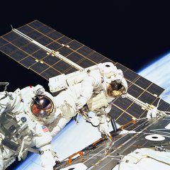 File - Astronauts Jerry L. Ross (left) and James H. Newman, both mission specialists, work together on the final of three space walks of the STS-88 mission.