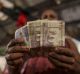 A vendor with Indian five hundred rupee banknotes at a vegetable wholesale market in Mumbai. India's top court has ...