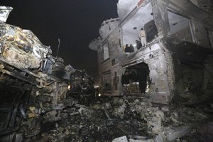 Civilians search for survivors in the rubble at the scene of a car bomb attack near the city of Hilla about 95 kilometers (60 miles) south of Baghdad, Iraq, Thursday, Nov. 24, 2016.