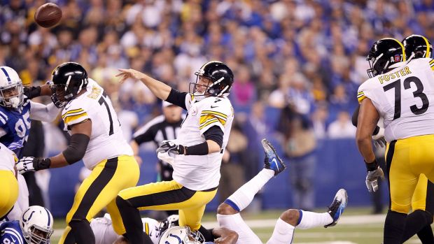 Off-balance: Ben Roethlisberger passes as he's tackled by T.J Green.