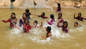 People bath in a canal on a hot summer day in Jammu, 1 June 2016,India.