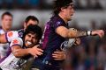 The Cowboys' Ethan Lowe is tackled by Tohu Harris, of the Storm, during the round 21 match.