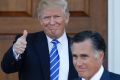 President-elect Donald Trump gives the thumbs-up as Mitt Romney leaves Trump National Golf Club in Bedminster, NJ.