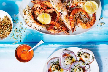 Grilled seafood platter with romesco sauce and herb crumbs