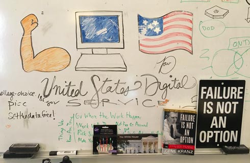 the USDS emoji logo written on a whiteboard