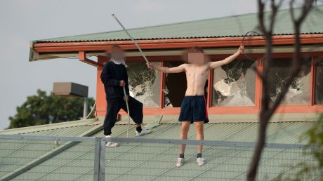 Youths protesting on the roof of the Parkville youth justice centre in March.