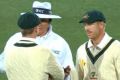 Steven Smith and David Warner have a quiet word with the umpire, but not quietly enough.