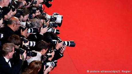 Photographers line the red carpet during the 68th annual Cannes Film Festival, in Cannes, France, 15 May 2015 (Copyright: picture-alliance/dpa/S. Nogier)