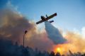 A firefighting plane from Greece fights a wildfire over Haifa, Israel.