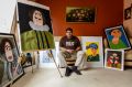 Patrick Francis, an award-winning artist, sportsman and autism ambassador, surrounded by his paintings at his family's ...
