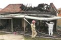 Fire investigators at the Essendon home on Monday.