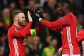 Back in business: Wayne Rooney celebrates his goal with Paul Pogba.