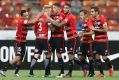 All square: The Wanderers celebrate after Jumpei's equaliser.