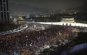 South Korean protesters march toward the presidential house during a rally calling for South Korean President Park Geun-hye to step down in Seoul, South Korea, Saturday, Nov. 19, 2016.