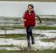 Tom Osborne, 11, splashes through the shallows of Lake George. 