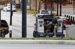 Members of the Columbus SWAT team work the scene around a parking garage on the campus of The Ohio State University Monday, Nov. 28, 2016, in Columbus, Ohio.