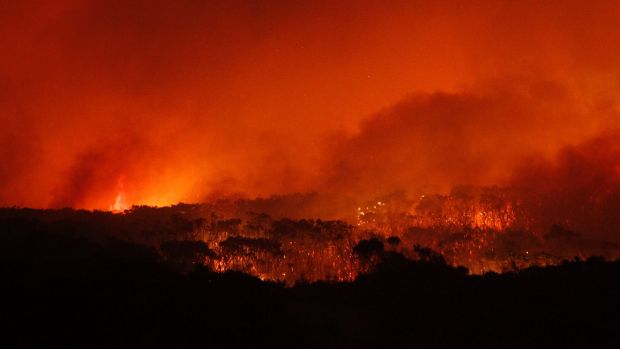 Flames sweep towards the heritage-listed NSW Central Coast town of Catherine Hill Bay on October 12, 2013.