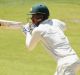 Back in the runs: Mitchell Starc sets off during his innings of 53 in Adelaide.