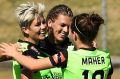 Michelle Heyman  celebrates with Canberra United teammates after scoring a goal.