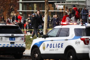 Students leave buildings surrounding Watts Hall as police respond to reports of an active shooter on campus at Ohio State University, Monday, Nov. 28, 2016, in Cincinnati.