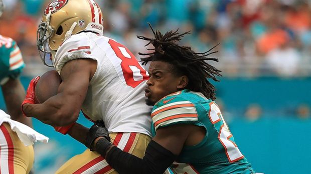 Rare sight:  Bobby McCain of the Miami Dolphins loses his helmet in a tackle.