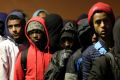 Migrants line up to register at a processing centre in the 'Jungle' camp in Calais last week.