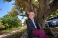 Dave Kendal under a Morton Bay Fig tree, a species which could become more abundant in a warmer Melbourne. 