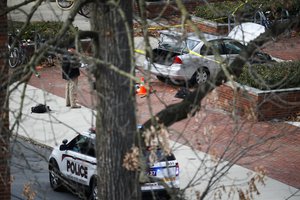 A car inside a police line outside Watts Hall rests on the sidewalk as authorities respond to reports of an active shooter on campus at Ohio State University, Monday, Nov. 28, 2016, in Columbus, Ohio.