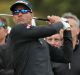 Refocused: Adam Scott tees off on day three of the World Cup of Golf at Kingston Heath Golf Club.