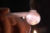 Video still - someone smoking a crystal meth pipe, October 2014.