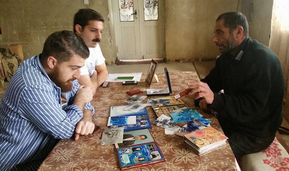 Dickran Khodanian (left) with his colleague Khatchig Joukadjian (far left) visit the the family of Armen Martirosyan, a fallen soldier