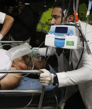 Medical staff from the San Juan de Dios hospital in La Ceja, Colombia, transfer one of the survivors of the crash, ...