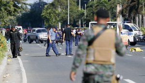 Philippine National Police bomb disposal squad comb the scene after detonating a suspicious package believed to be suspected IED or Improvised Explosive Device that was found in the trash bin near the U.S. Embassy in Manila, Philippines Monday, Nov. 28, 2016.