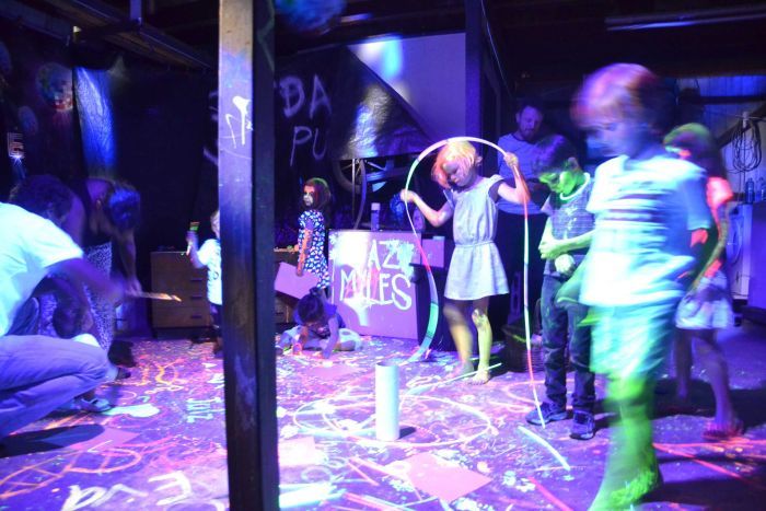 Children play under coloured lights at Julian Scharf's party.