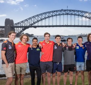The top 10 picks pose in front of the Sydney Harbour Bridge on Saturday morning.