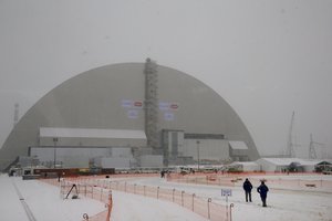 Workers inspect the New Safe Confinement (NSC) movable enclosure in Chernobyl, Ukraine, Tuesday, Nov. 29, 2016.