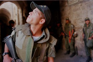 An Israeli border police officer scans the roofs of Jerusalem's Old City during the traditional Friday Prayer at the Temple Mount in Jerusalem Friday Oct 4 1996.