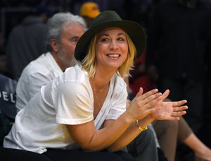 Actress Kaley Cuoco claps during the first half of an NBA basketball game between the Los Angeles Lakers and the Houston Rockets, Sunday, Jan. 17, 2016, in Los Angeles