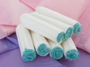 Sanitary napkins and tampons on white background