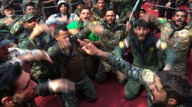 Members of the Shiite Popular Mobilisation forces mourn during Shiite rites of the month of Muharram inside the shrine ...