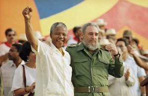 In this July 27, 1991 file photo, Cuban President Fidel Castro, right, and African leader Nelson Mandela gesture during the celebration of the "Day of the Revolution" in Matanzas.