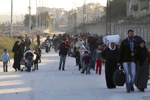 In this Sunday, Nov. 27, 2016 photo provided by the Rumaf, a Syrian Kurdish activist group, which has been authenticated based on its contents and other AP reporting, shows people fleeing rebel-held eastern neighborhoods of Aleppo into the Sheikh Maqsoud area that is controlled by Kurdish fighters, Syria.