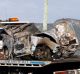 The mangled wreckage of the car is taken away after the fatal crash in Dapto.