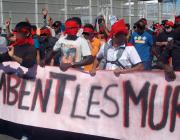 Migrants demonstrate, Calais: banner reads Tombent les murs [May the walls fall]